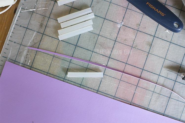 one eight inch strip of purple faux leather and one glue stick segment will be used to make a candle for the birthday cake costume