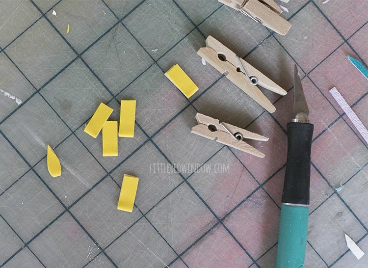 dried folded yellow faux leather pieces with one cut into a flame shape for the birthday candles