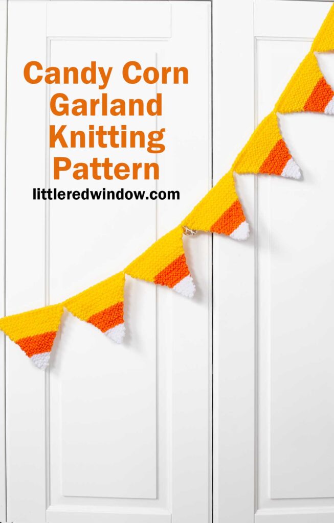 A candy corn garland of knitted yellow, orange, and white shapes hangs across white cabinet doors. Text reads: 