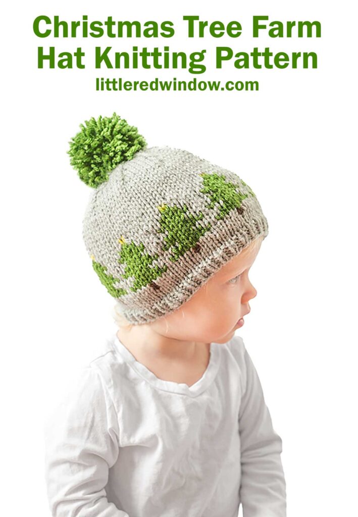 A young child dons a knitted hat adorned with green tree patterns and a large green pom-pom, set against a crisp white background. Above them, the text reads