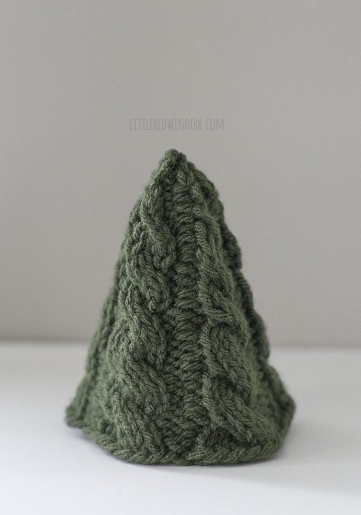 The Small Cozy Christmas tree knitting pattern features a simple twisted cable pattern and it knits up in no time!