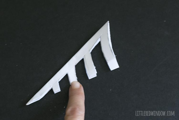 triangle with negative space cut out in spider web shape