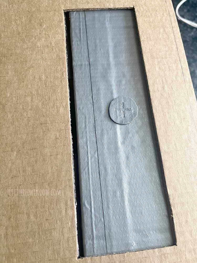 close up of the duct tape phillips head screw on top of the duct tape box flap to make it look like a pencil sharpener