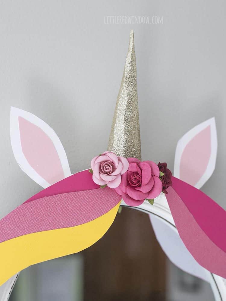 Add some cute little scrapbooking flowers to the top of your DIY unicorn mirror