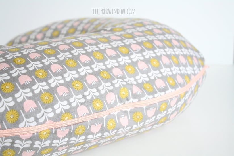 Closeup of pink zipper along edge of nursing pillow