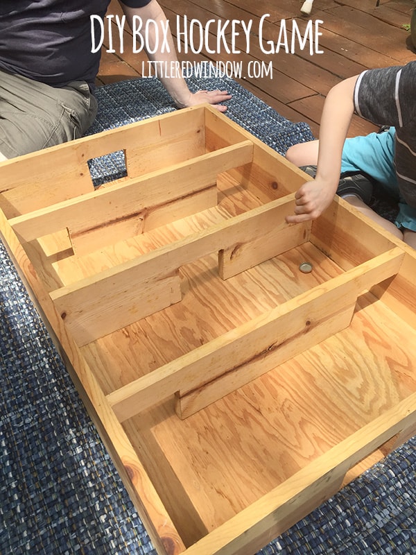 Build and play your own DIY Box Hockey Game all you need are two popsicle sticks and a bottlecap! | littleredwindow.com