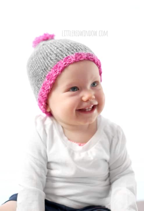 This little one is happy to donate hats to charity, they knit up super fast with the Do-Gooder free baby hat knitting pattern!