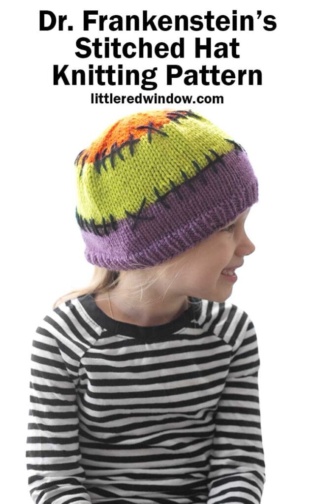 child in black and white striped shirt wearing a purple acid green and orange colorblocked knit hat with black stitching lines between the colors looking off to the right in front of a white background