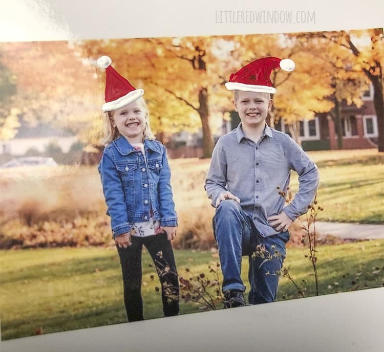 closeup of photo with finished painted santa hats on two smiling kids