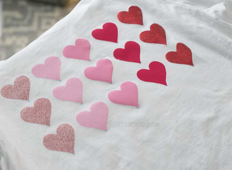 after image showing white tshirt with 18 vinyl hearts ironed on the front in shades of pink