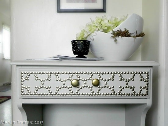 table with a drawer and nailhead design