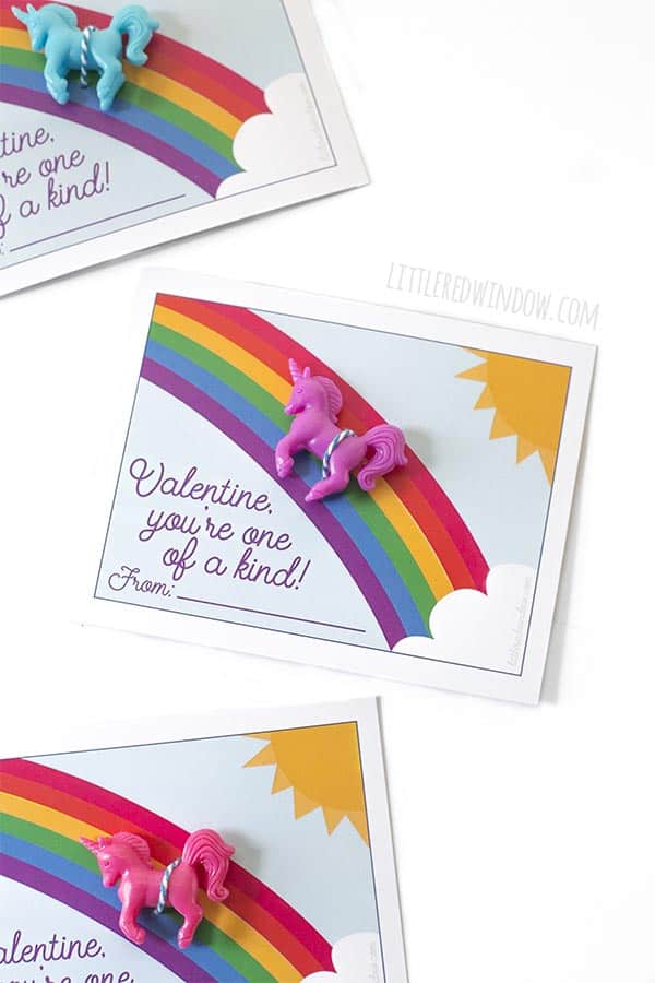 Closeup of free printable unicorn valentines cards with purple unicorn toy!