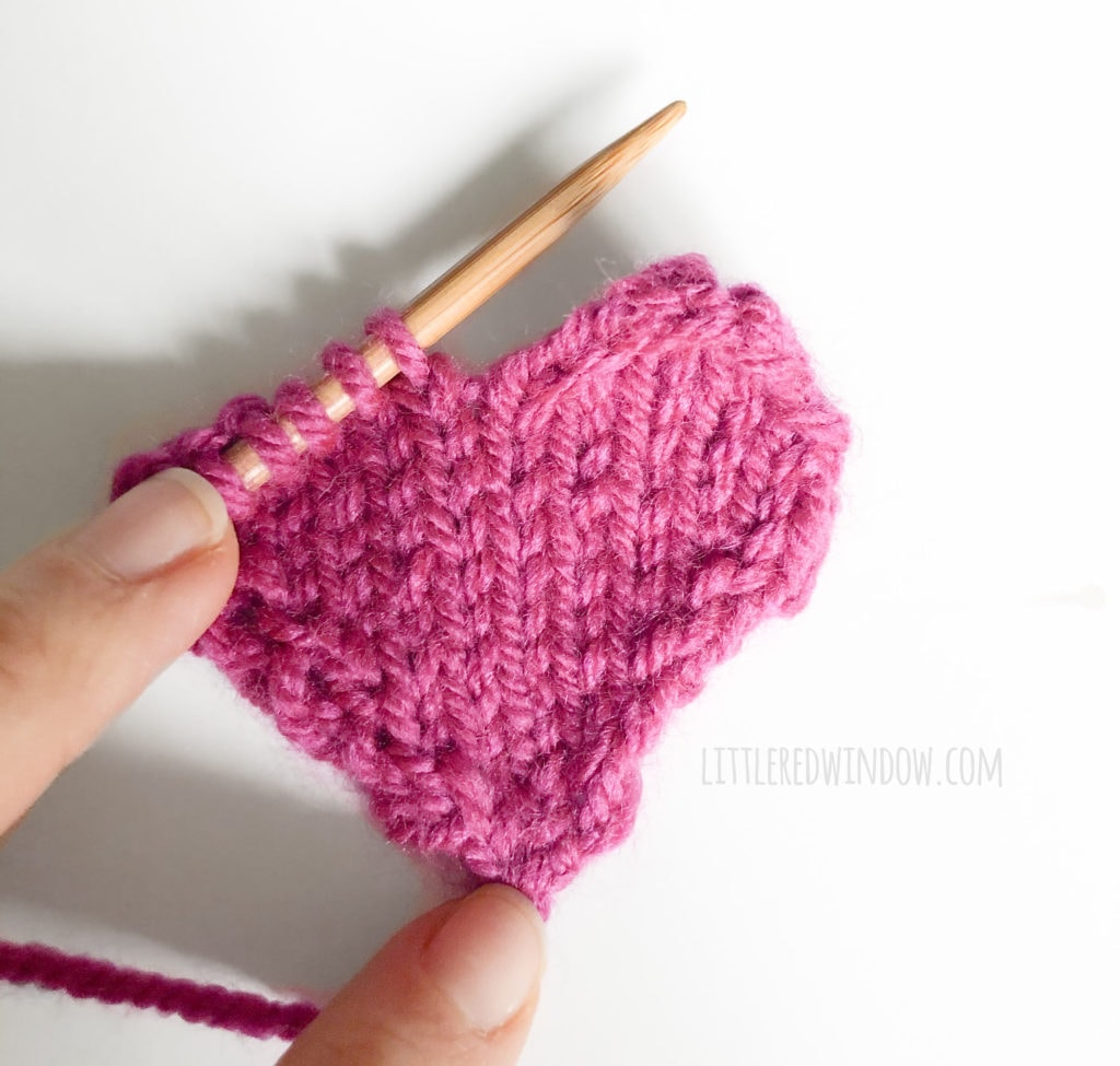 Work with only a few stitches at a time to form the top of the heart shape for the gathered heart hat knitting pattern!