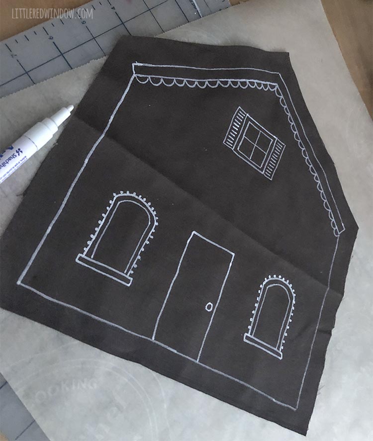 progress shot of brown fabric gingerbread house shape being decorated