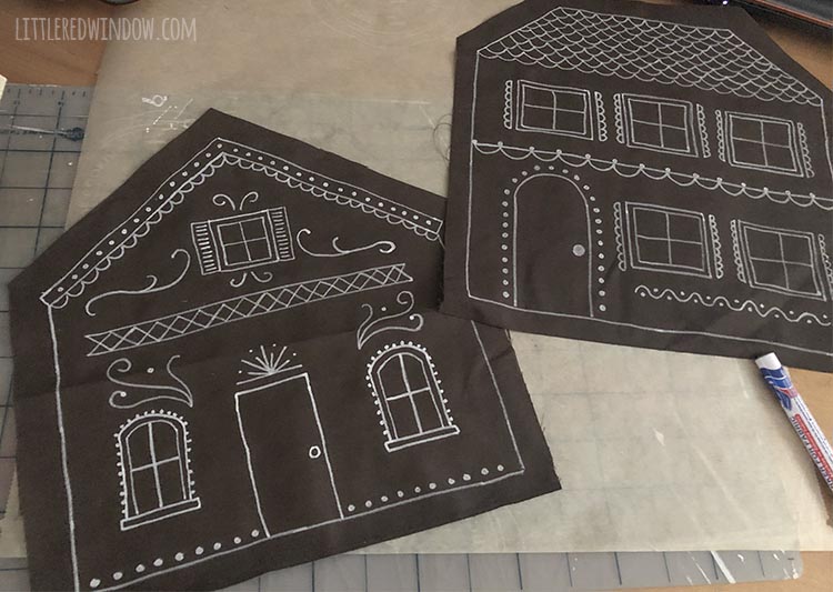 two flat pieces of brown fabric decorated like gingerbread houses