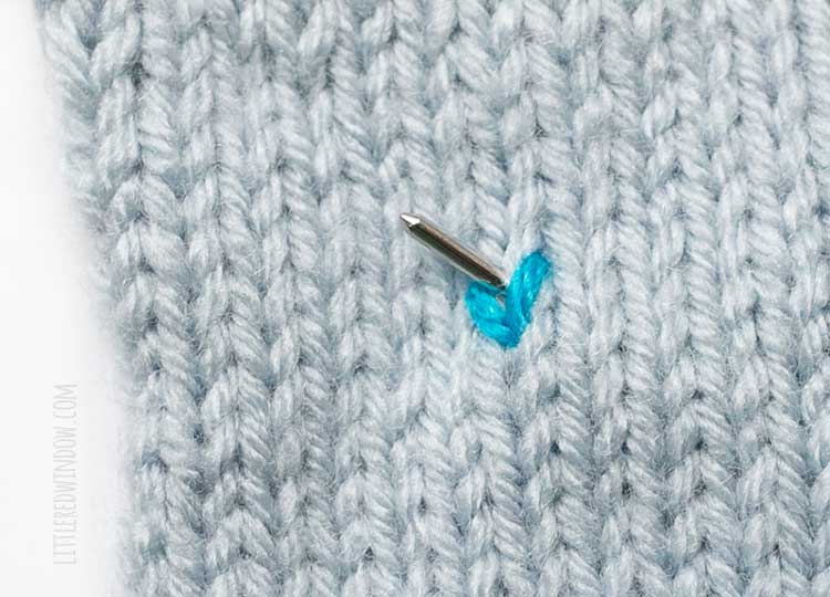 showing where to insert the yarn needle to make a second duplicate stitch above the first