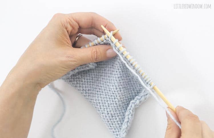 Insert the right needle through the first stitch from right to left to form a purl stitch