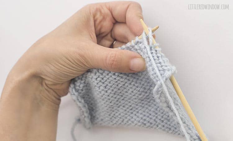 To ptbl, wrap the yarn around the tip of the right knitting needle