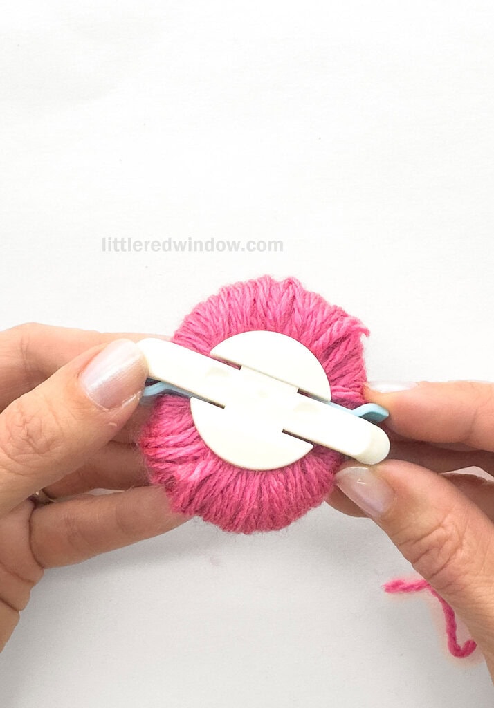 Close this half of the pom pom maker and open the arches on the other side.