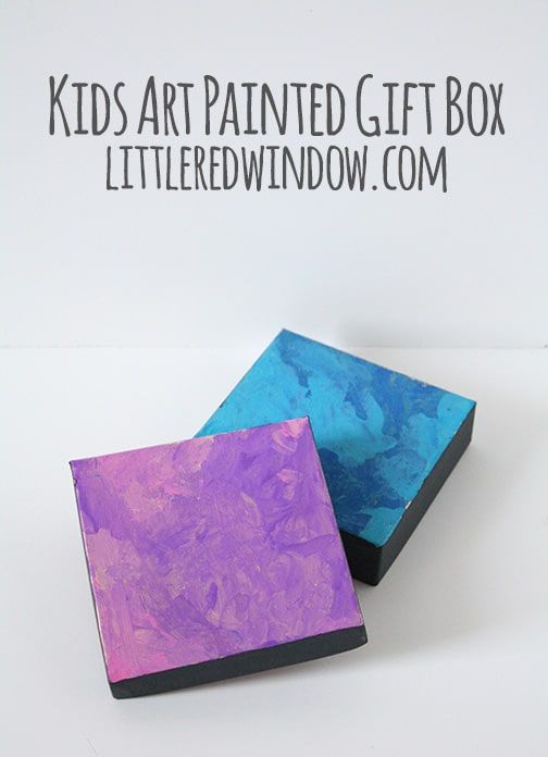 two jerely gift boxes with pink and blue swirly paint on the lids