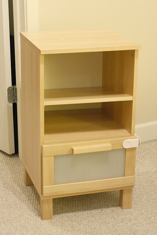 light wood IKEA nighstand with two shelves and drawer below