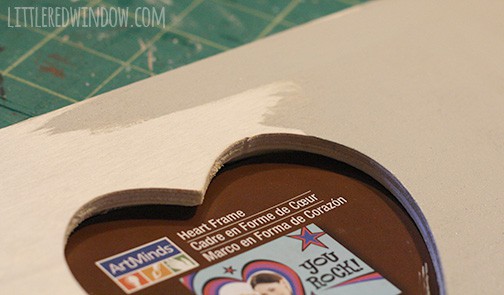 Closeup of fram being painted light gray