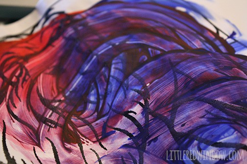 blue and red swirled kid's fingerpainting on white paper