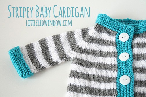 closeup of gray and white striped knit baby cardigan with blue trim