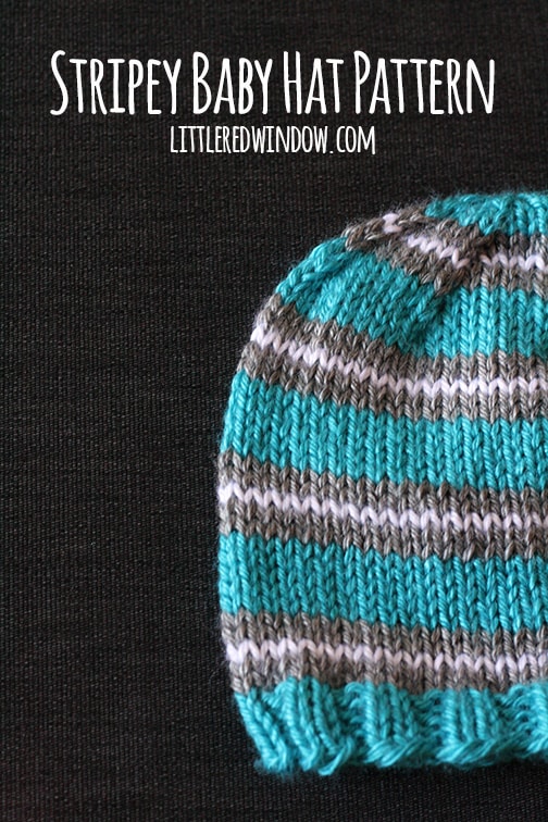 Closeup of Blue hat with gray and white stripes on a dark background