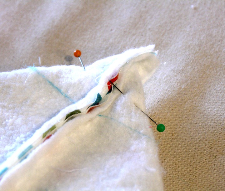 Tote bag inside out with the corner folder across the seam and pinned to make a box corner