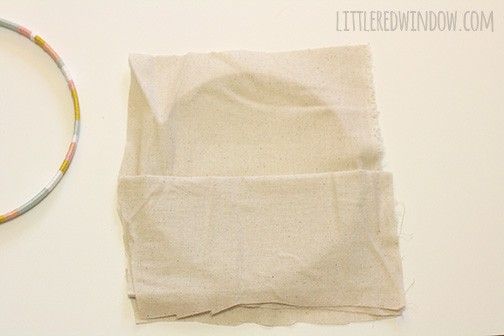 Inner circle of emrboider hoop draped with tan fabric