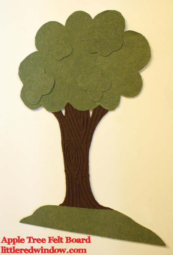 Green tree with brown bark made of felt on a flat white board