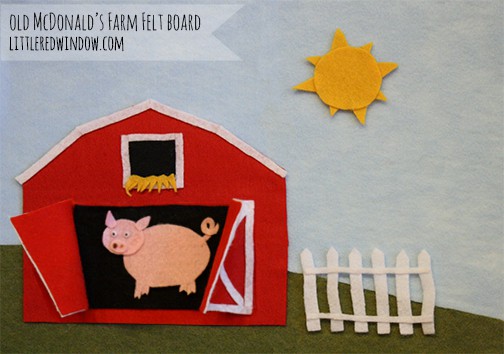 Closeup of felt barn with doors open and a pig inside!