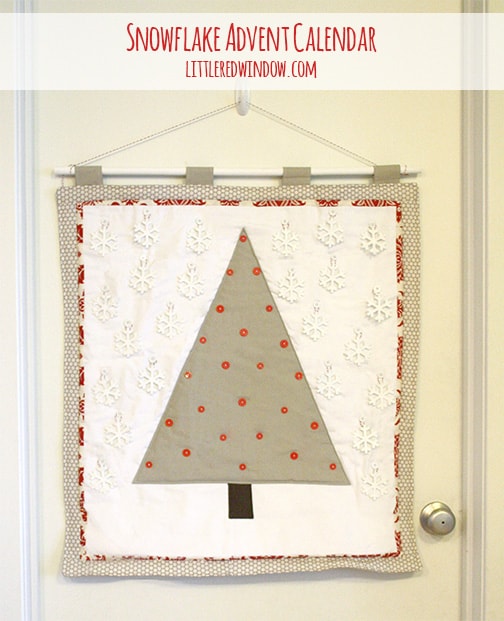 Quilted snowflake advent calendar with all of the snowflakes in the 'sky