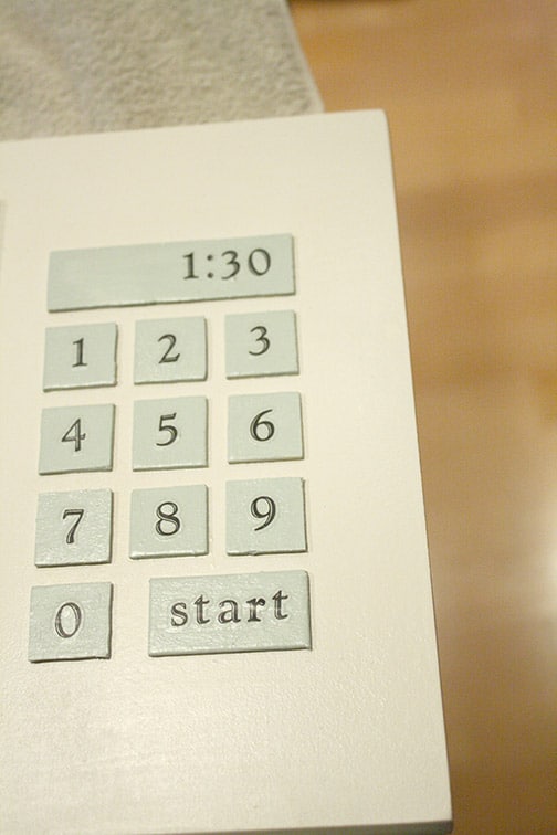 Microwave buttons glued in place in a grid on the microwave door