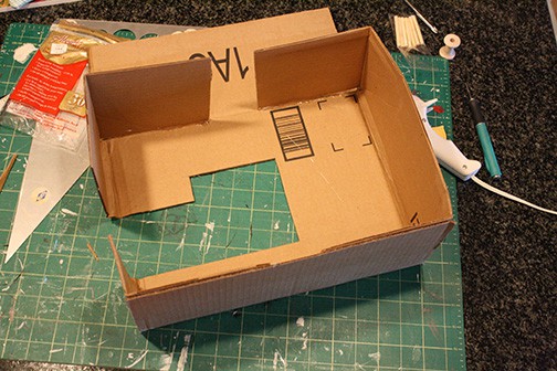 Strips of cardboard attached to sewing machine shape to make the sides