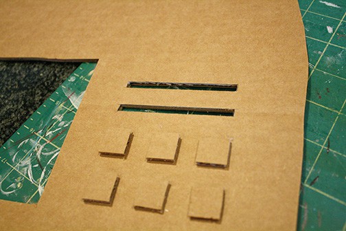 two slots cut above the buttons on the side of the machine