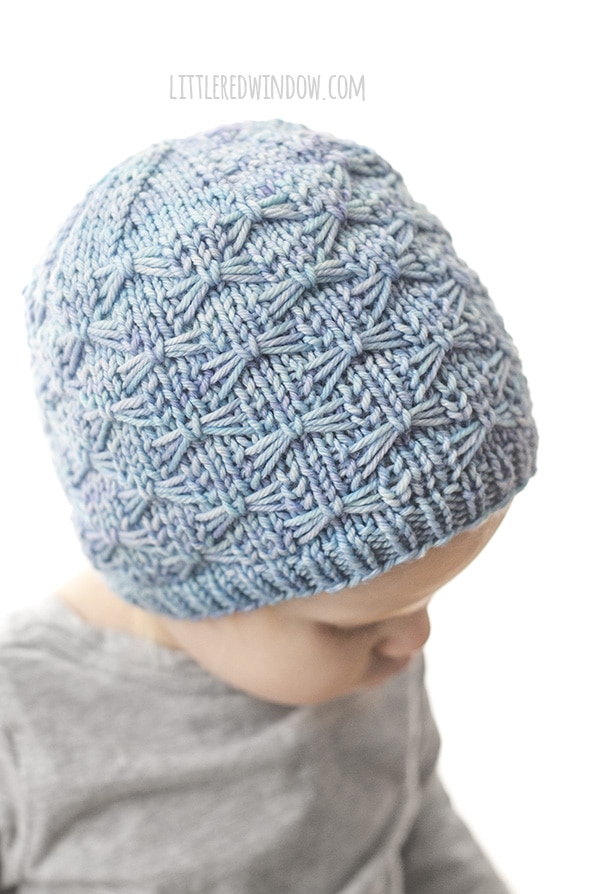 side view of light blue butterfly stitch hat