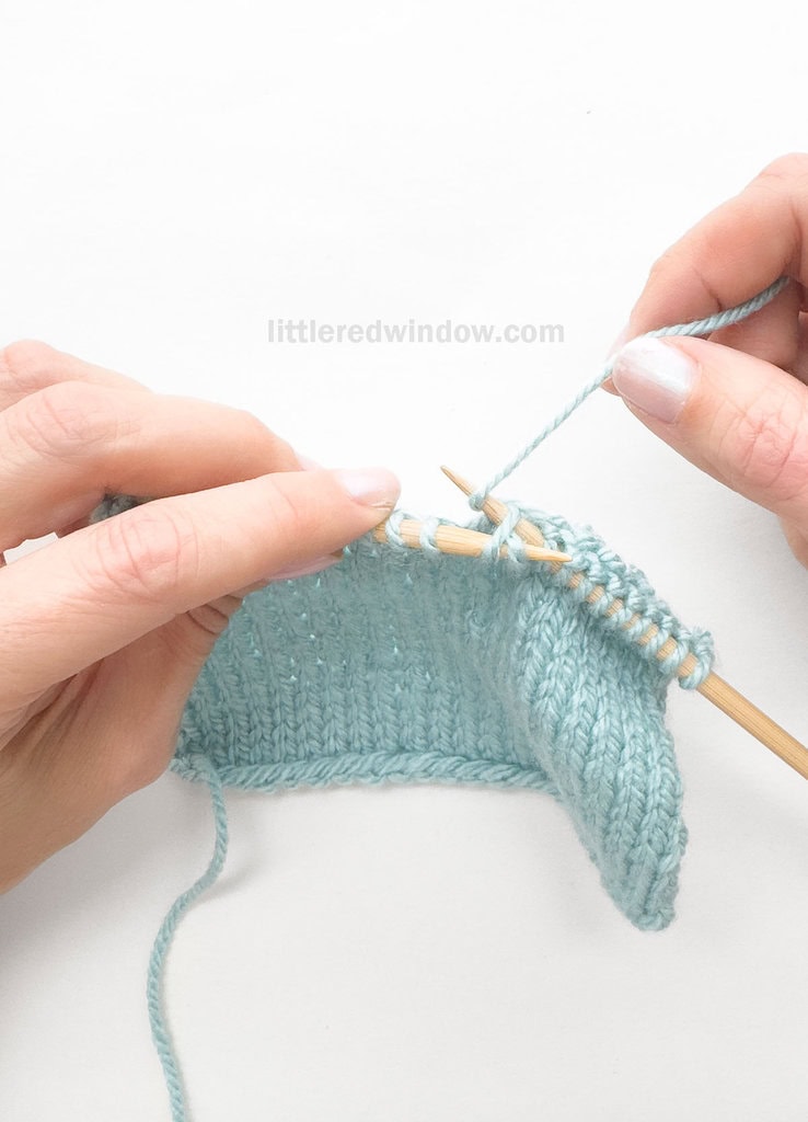 Skip the 1st stitch on the left needle and knit into the BACK of the 2nd, leaving both stitches on the left needle.