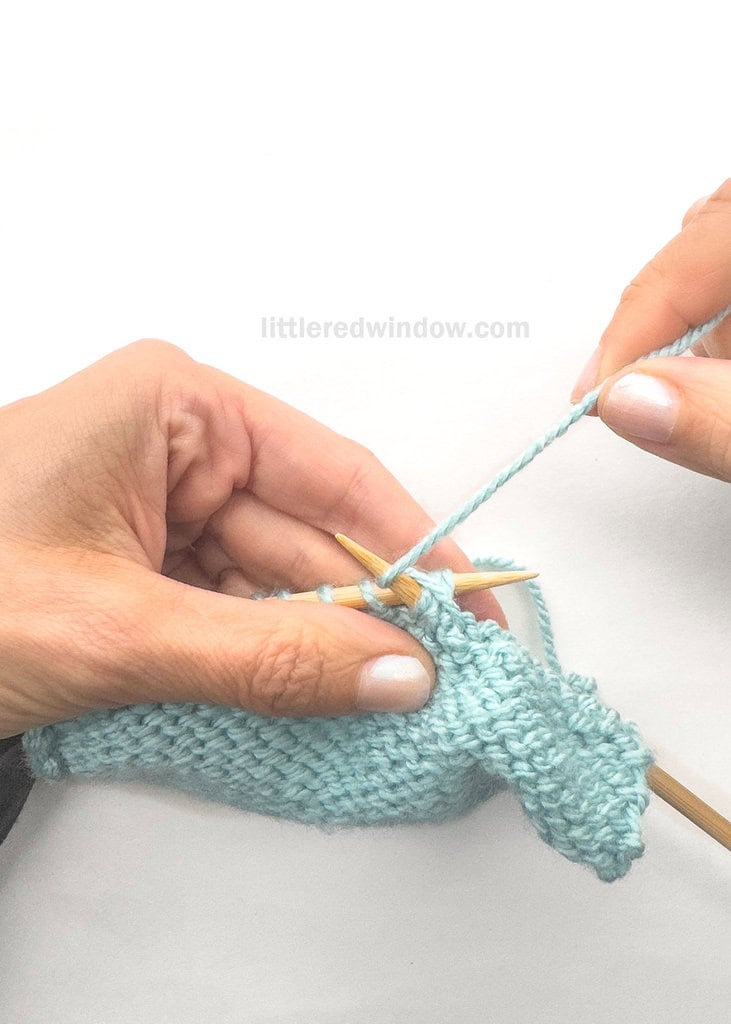 Wrap the yarn around the tip of the right needle as you would for a normal purl stitch.
