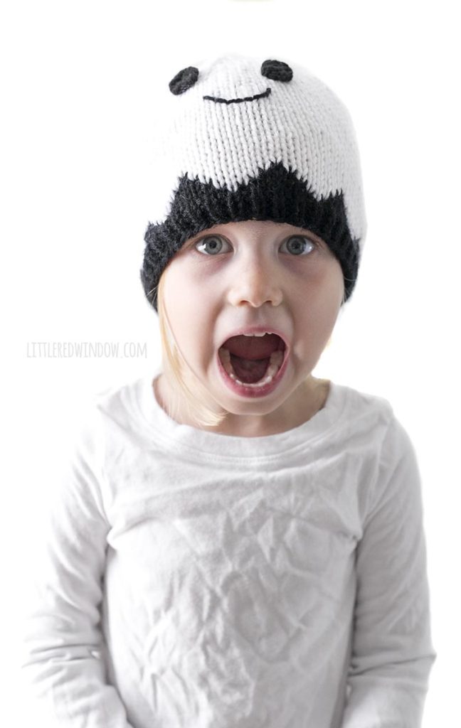 Little girl wearing white ghost hat and making surprised face