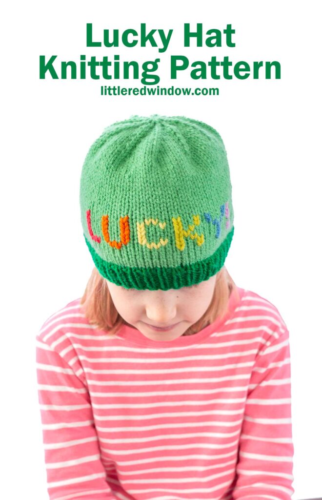 Child wearing a green knitted hat with the word