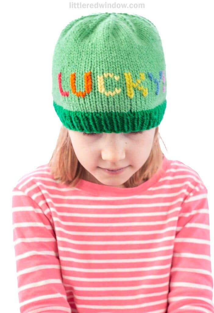 Child wearing a green knit hat with
