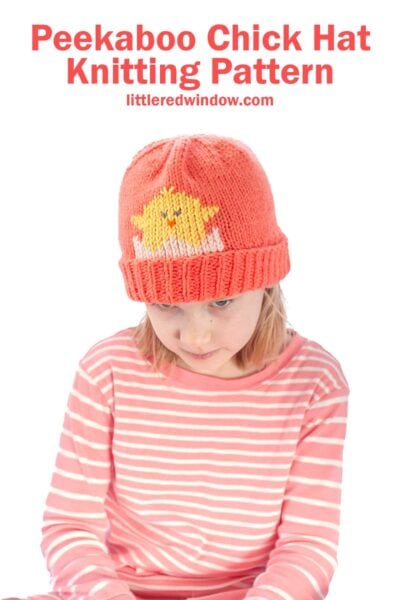 A child dons a pink and white striped outfit paired with a knitted orange hat, showcasing an adorable yellow chick design. The heading "Peekaboo Chick Hat Knitting Pattern" appears above, directing you to explore this charming creation at littleredwindow.com.