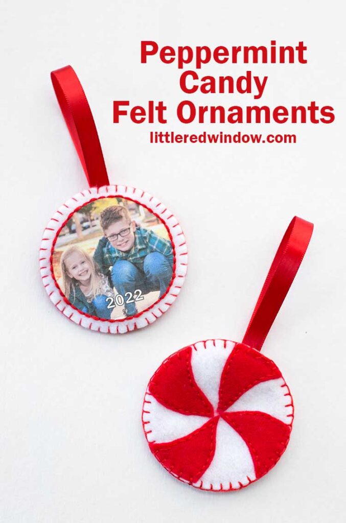 two round red and white felt ornaments one with a photo of kids on it and the other that looks like a peppermint candy with red hanging ribbons 