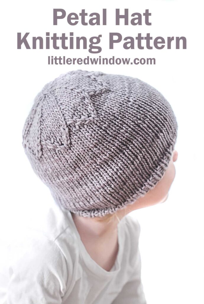 A child in a gray hat with a petal design on top looks to the right. Above, the text reads