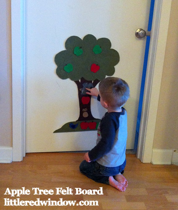 Toddler playing with Apple Tree Felt Board