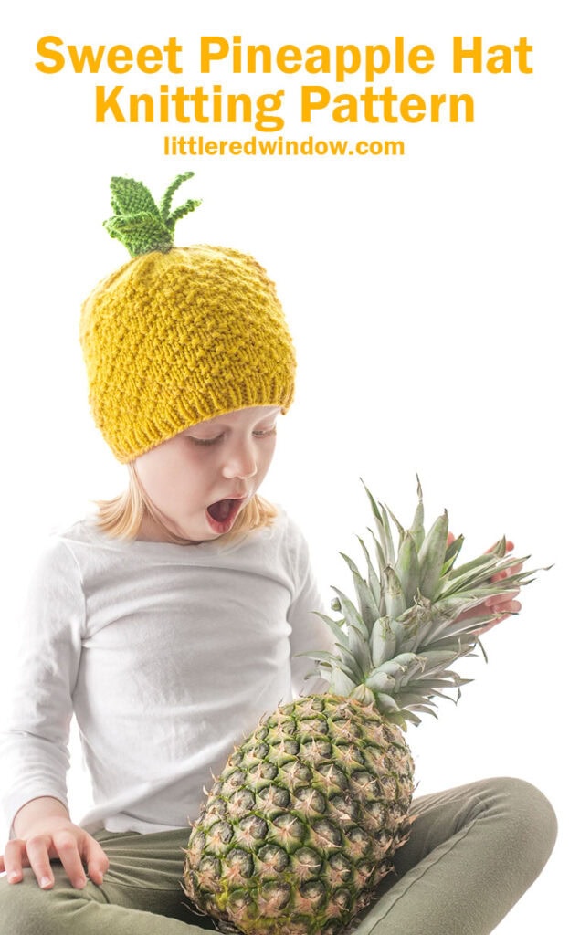 surprised kid holding a pineapple and wearing a knit hat that looks like a pineapple