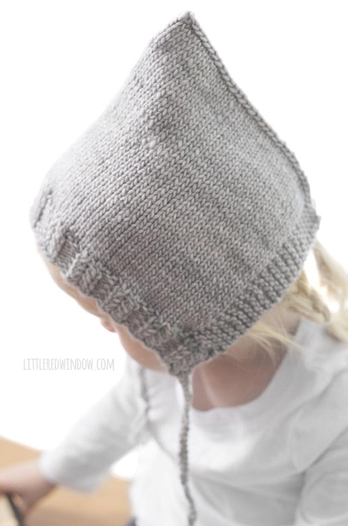 Side view of Sweet Pixie Bonnet showing twisted rib trim and 3 needle cast off at the back