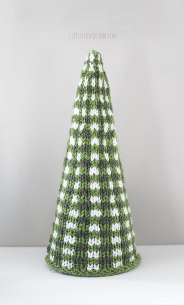 large green and white knit christmas tree on a white table